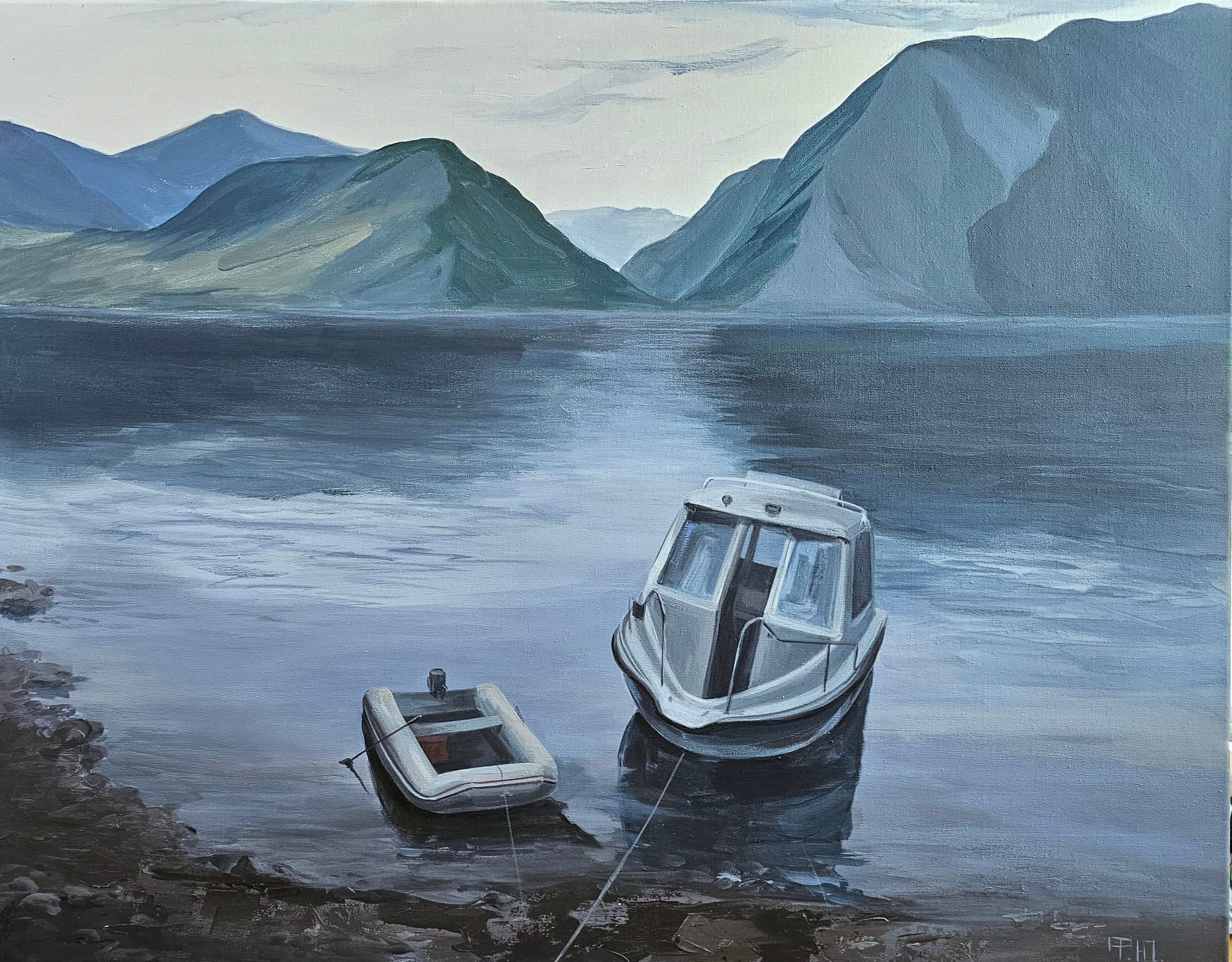 Two boats at the shore of a mountain lake, with clouded mountains behind